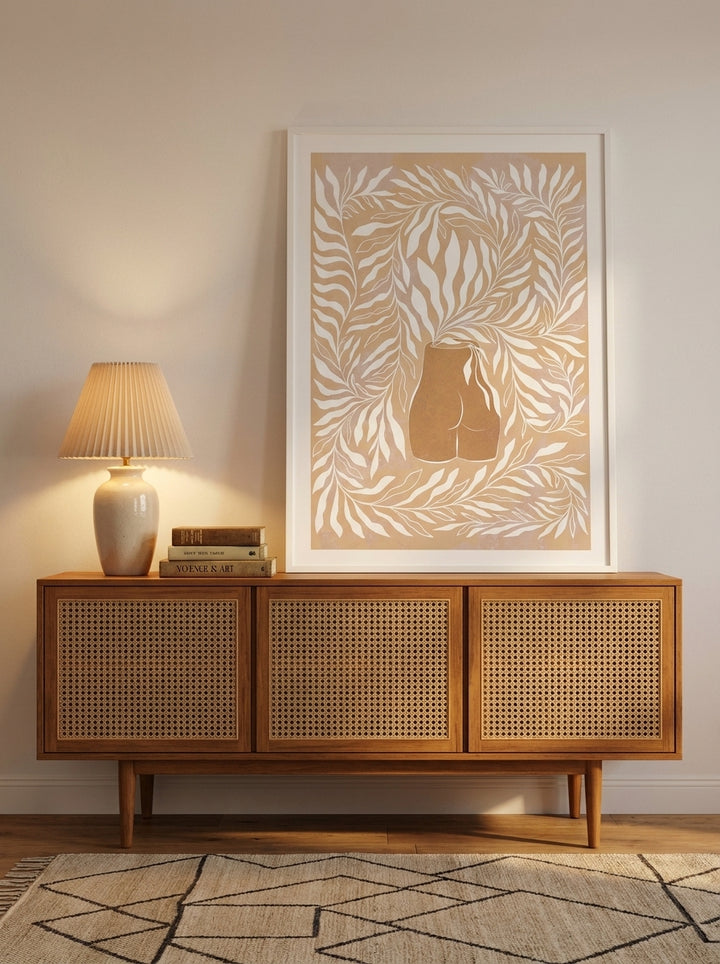 Modern wall art print standing on a sideboard in a mid-century bedroom