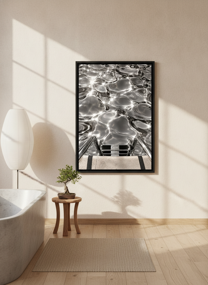 Canvas wall art with a black surround styled on the wall in a warm Japandi bathroom