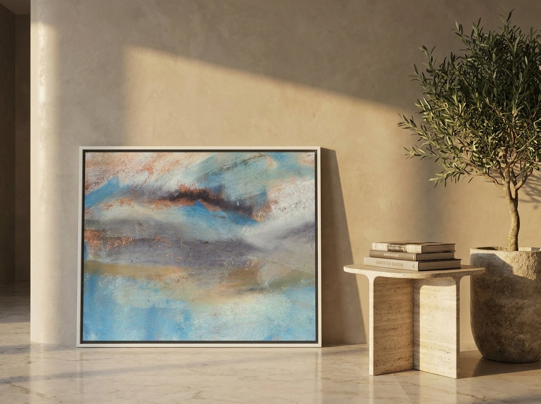 Canvas wall art with a white surround leaning against the wall in a luxe living room