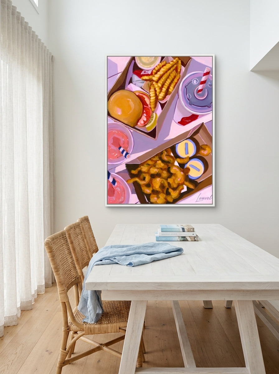 Oversized statement canvas wall art with a white surround styled on the wall in a coastal dining room