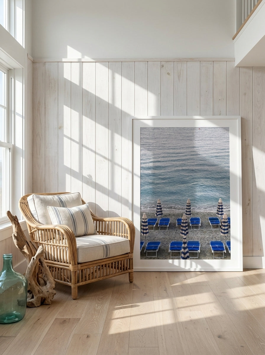 Oversized statement modern wall art print leaning against the wall in a coastal living room