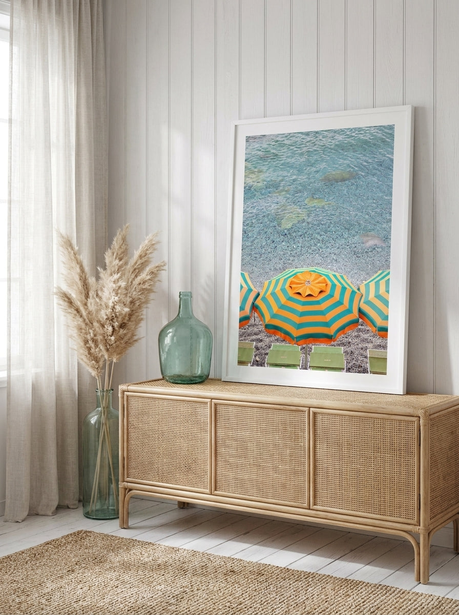 Modern wall art print standing on a sideboard in a coastal living room