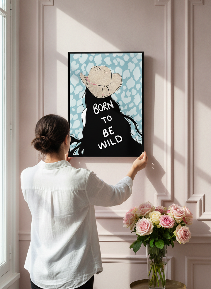 Person holding canvas wall art with a black surround in a Parisian living room