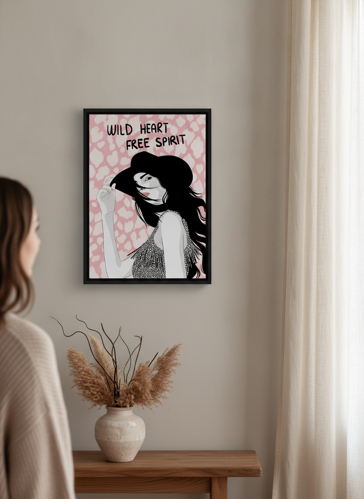 Person holding canvas wall art with a black surround in a warm Japandi living room