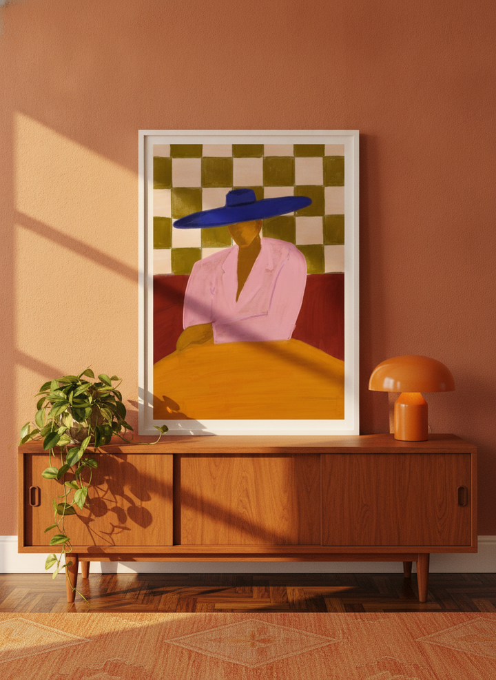 Modern wall art print standing on a sideboard in a retro 70s dining room