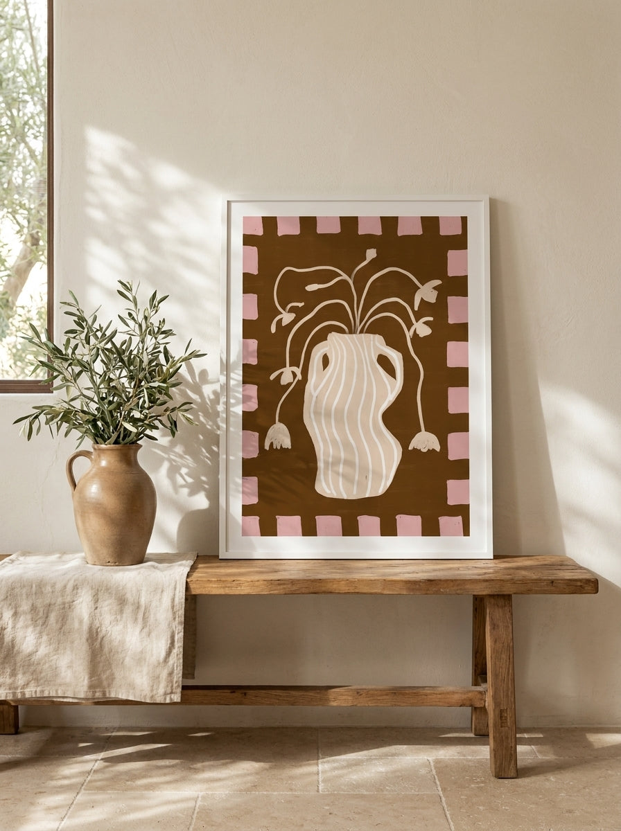 Modern wall art print standing on a bench in a Mediterranean bedroom