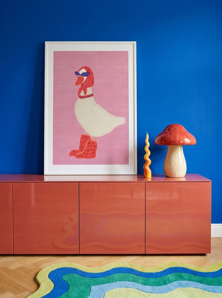 Modern wall art print standing on a sideboard in a colourful eclectic living room