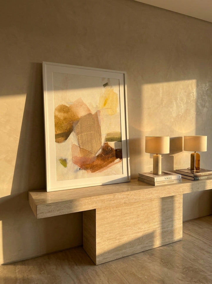 Modern wall art print standing on a console in a luxe bedroom