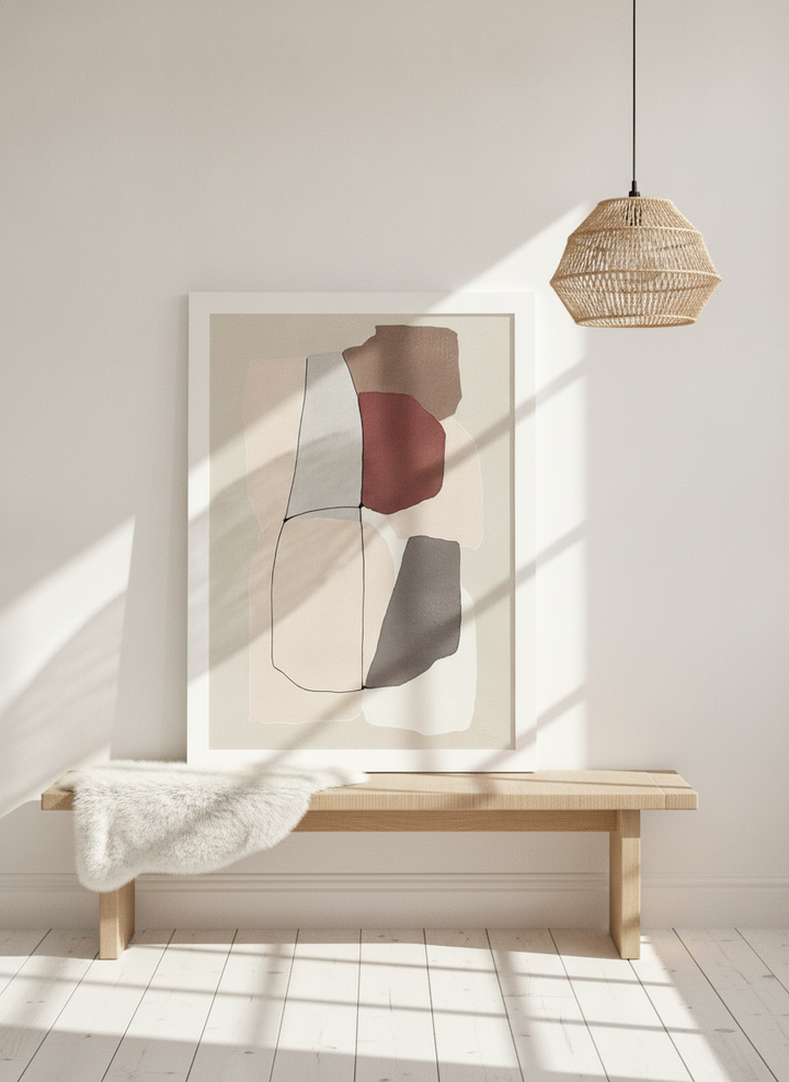 Modern wall art print standing on a bench in a bright Scandinavian home office