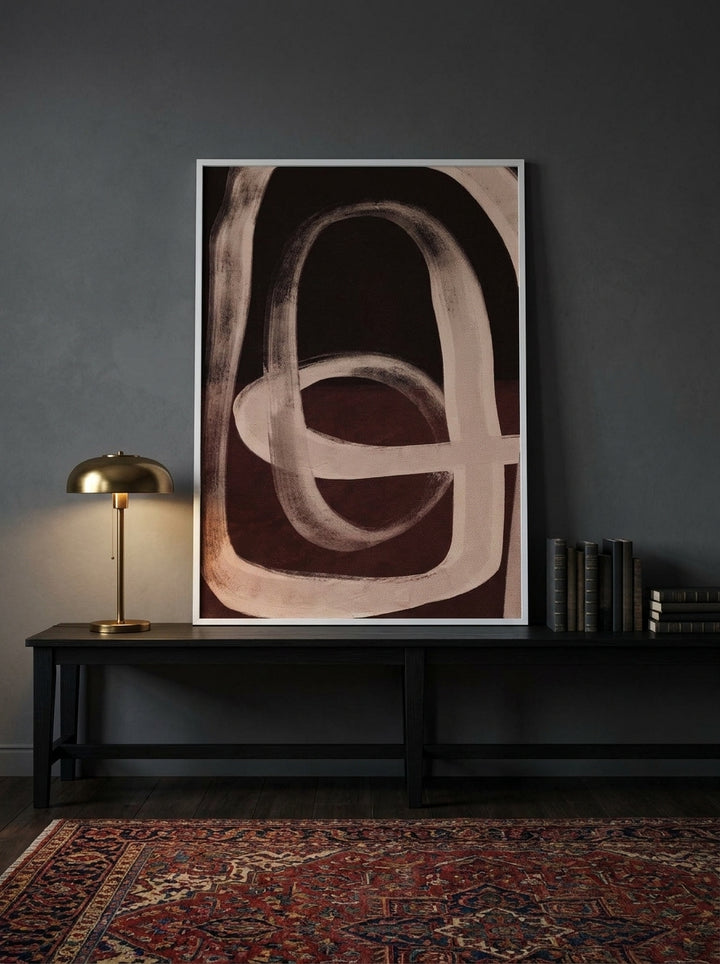 Modern wall art print standing on a console in a moody home office