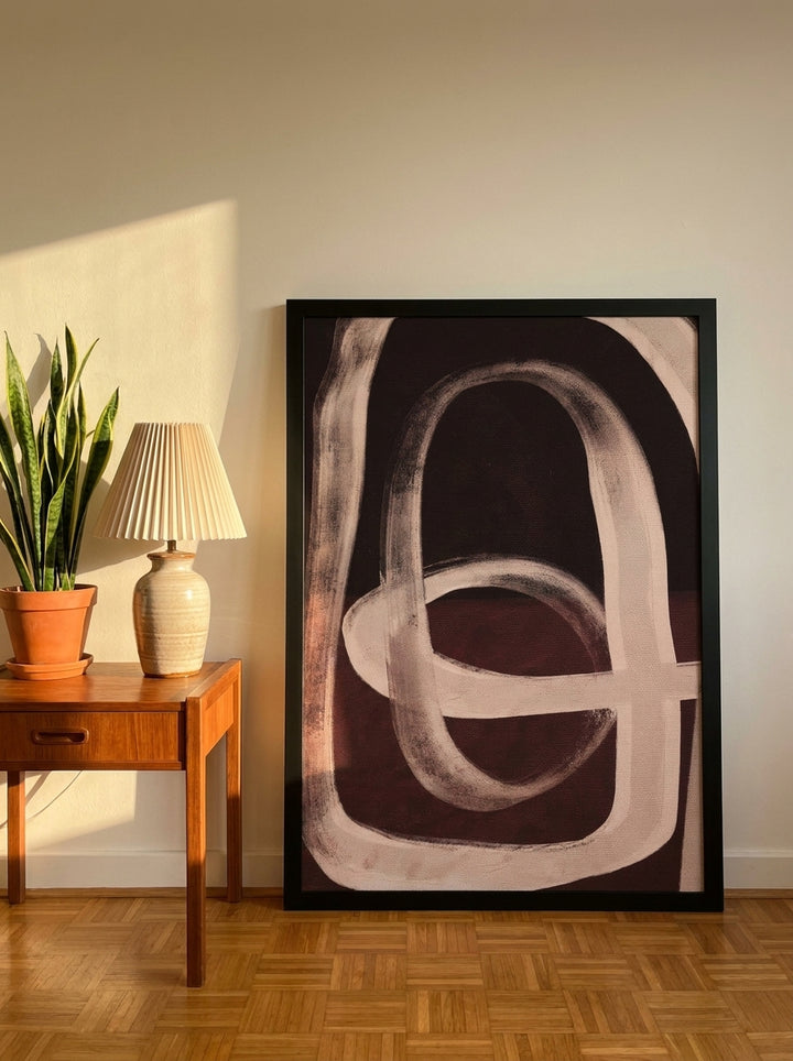 Oversized statement modern wall art print leaning against the wall in a mid-century bedroom