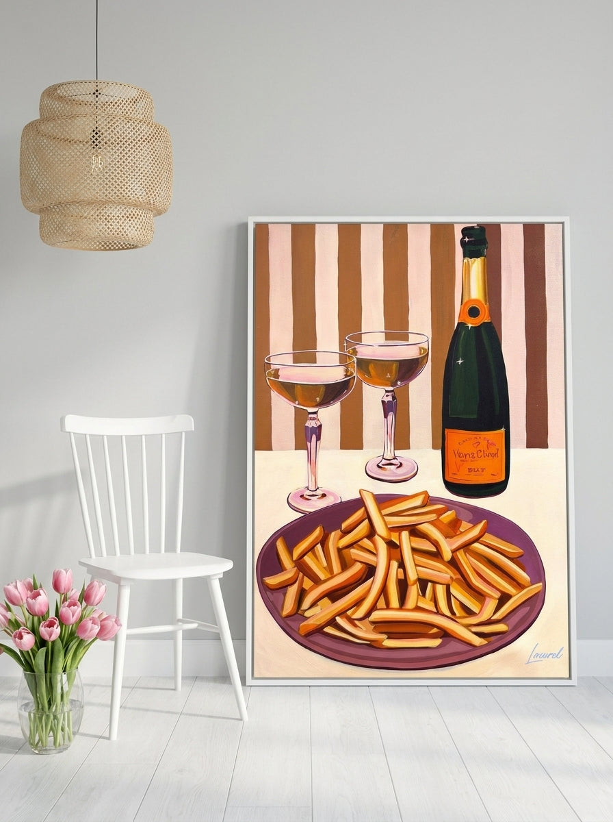 Oversized statement canvas wall art with a white surround leaning against the wall in a bright Scandinavian dining room