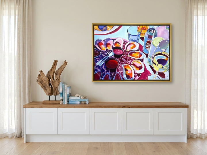 Canvas wall art with a gold leaf surround styled on the wall in a coastal kitchen