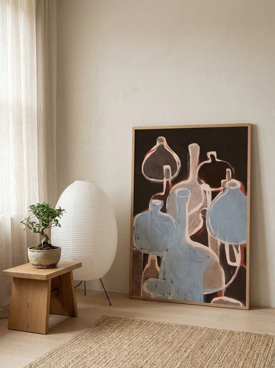 Modern wall art print leaning against the wall in a warm Japandi bedroom