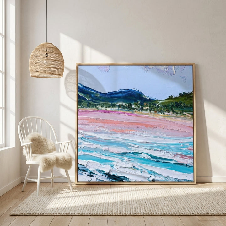 Oversized statement canvas wall art with a natural timber surround leaning against the wall in a bright Scandinavian living room
