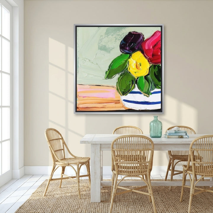 Canvas wall art with a silver leaf surround styled on the wall in a coastal dining room