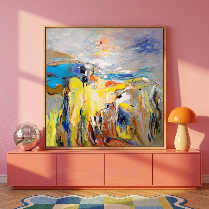 Canvas wall art with a natural timber surround standing on a sideboard in a colourful eclectic home office