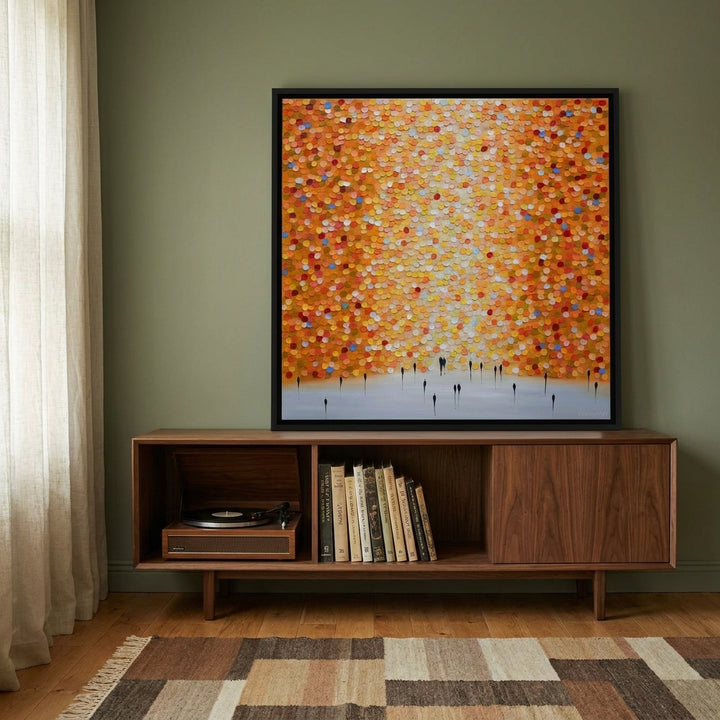 Canvas wall art with a black surround standing on a sideboard in a mid-century home office