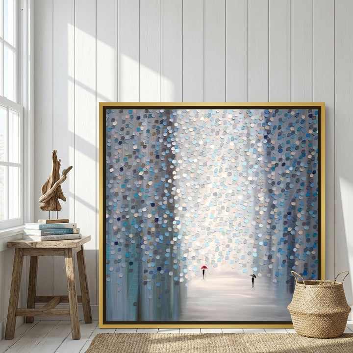 Canvas wall art with a gold leaf surround leaning against the wall in a coastal dining room
