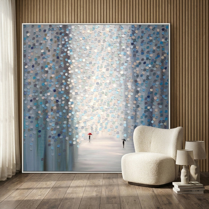 Oversized statement canvas wall art with a white surround leaning against the wall in a luxe living room