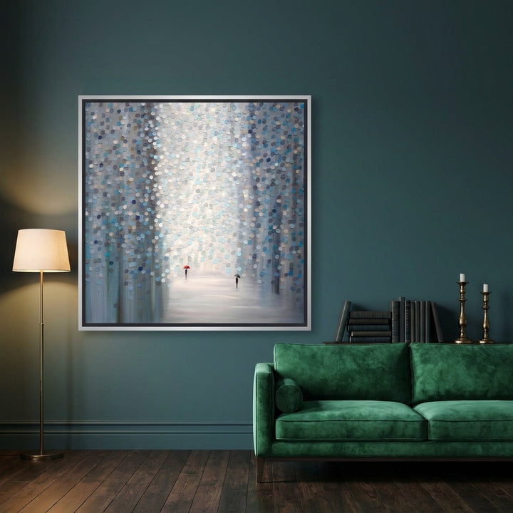 Oversized statement canvas wall art with a silver leaf surround styled on the wall in a moody living room