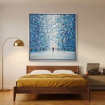 Canvas wall art with a silver leaf surround styled on the wall in a mid-century bedroom
