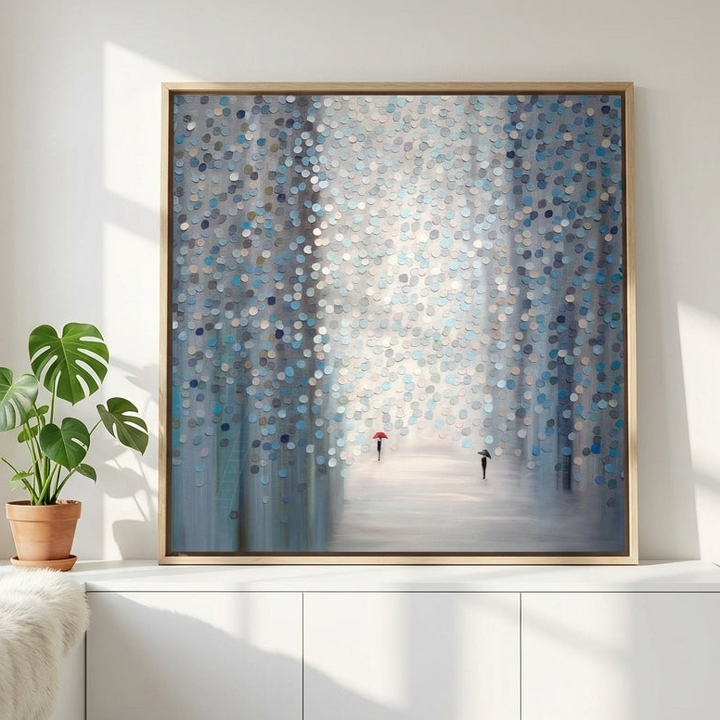 Canvas wall art with a natural timber surround standing on a sideboard in a bright Scandinavian bedroom