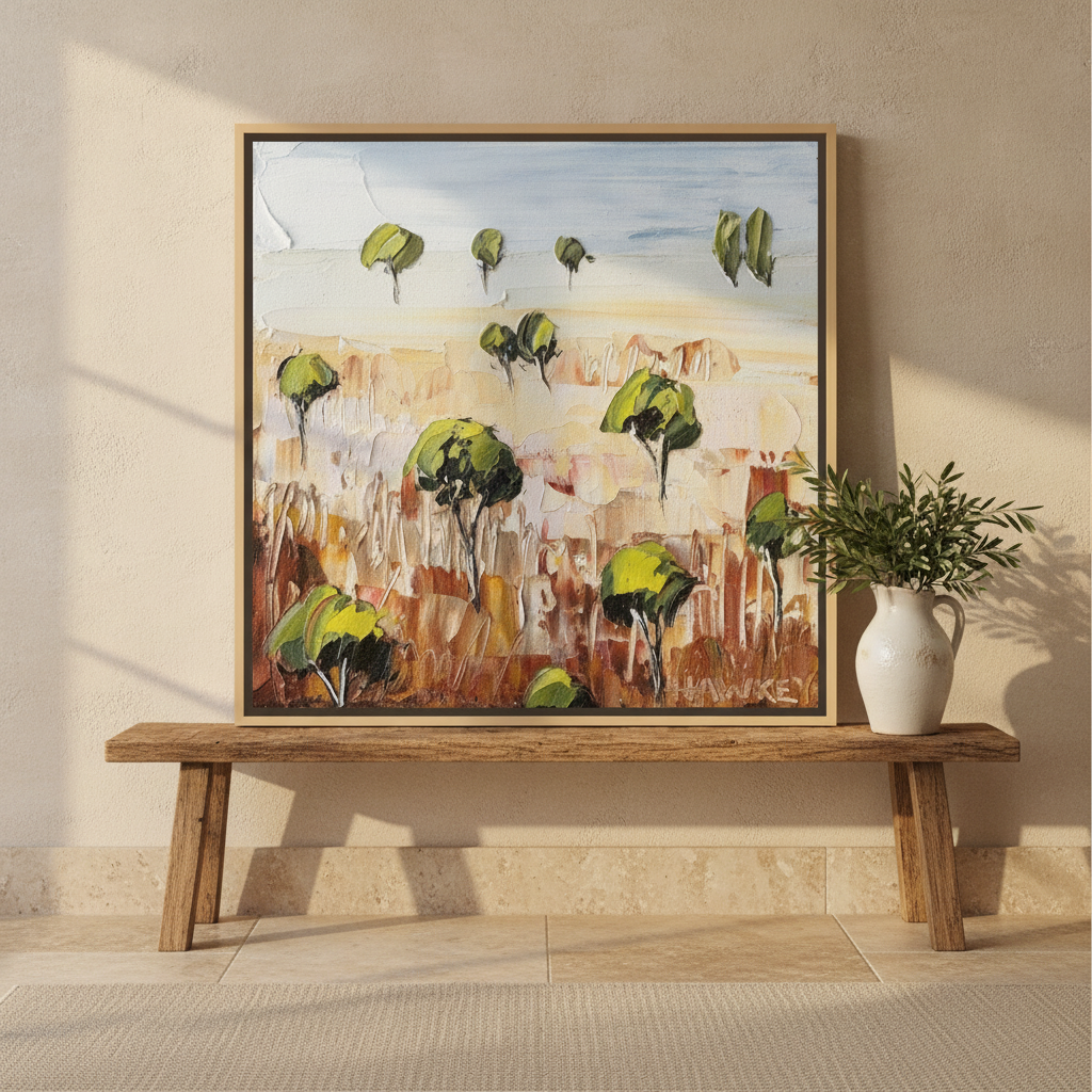 Canvas wall art with a natural timber surround standing on a bench in a Mediterranean home office