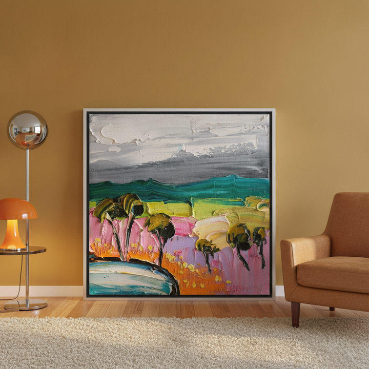 Canvas wall art with a silver leaf surround leaning against the wall in a retro 70s living room
