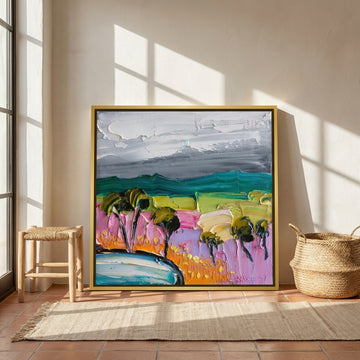 Canvas wall art with a gold leaf surround leaning against the wall in a Mediterranean bedroom