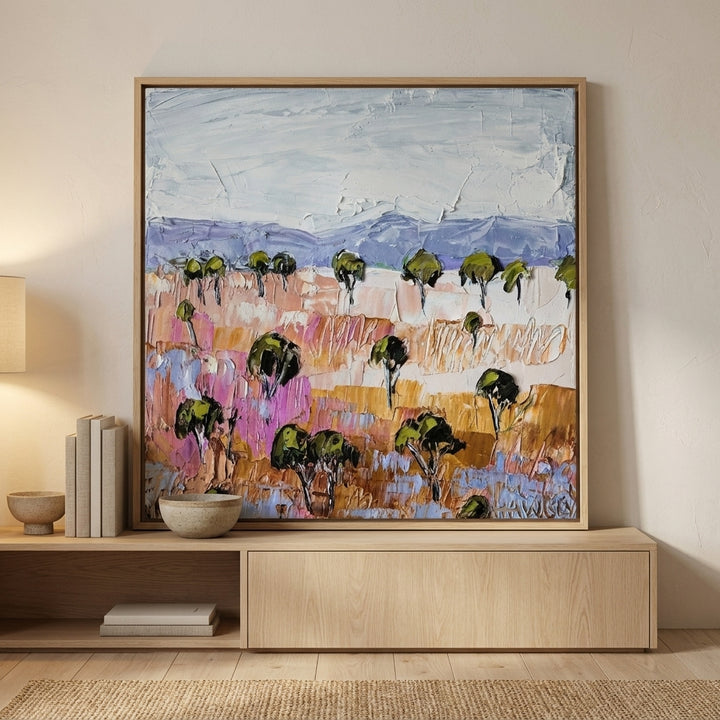 Canvas wall art with a natural timber surround standing on a sideboard in a warm Japandi home office