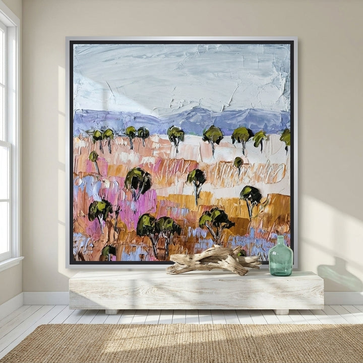 Canvas wall art with a silver leaf surround styled on the wall in a coastal living room