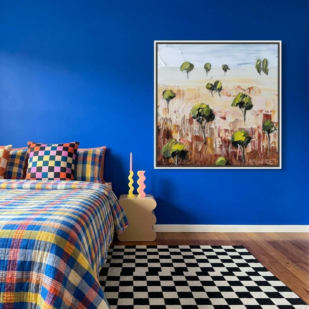 Canvas wall art with a white surround styled on the wall in a colourful eclectic bedroom