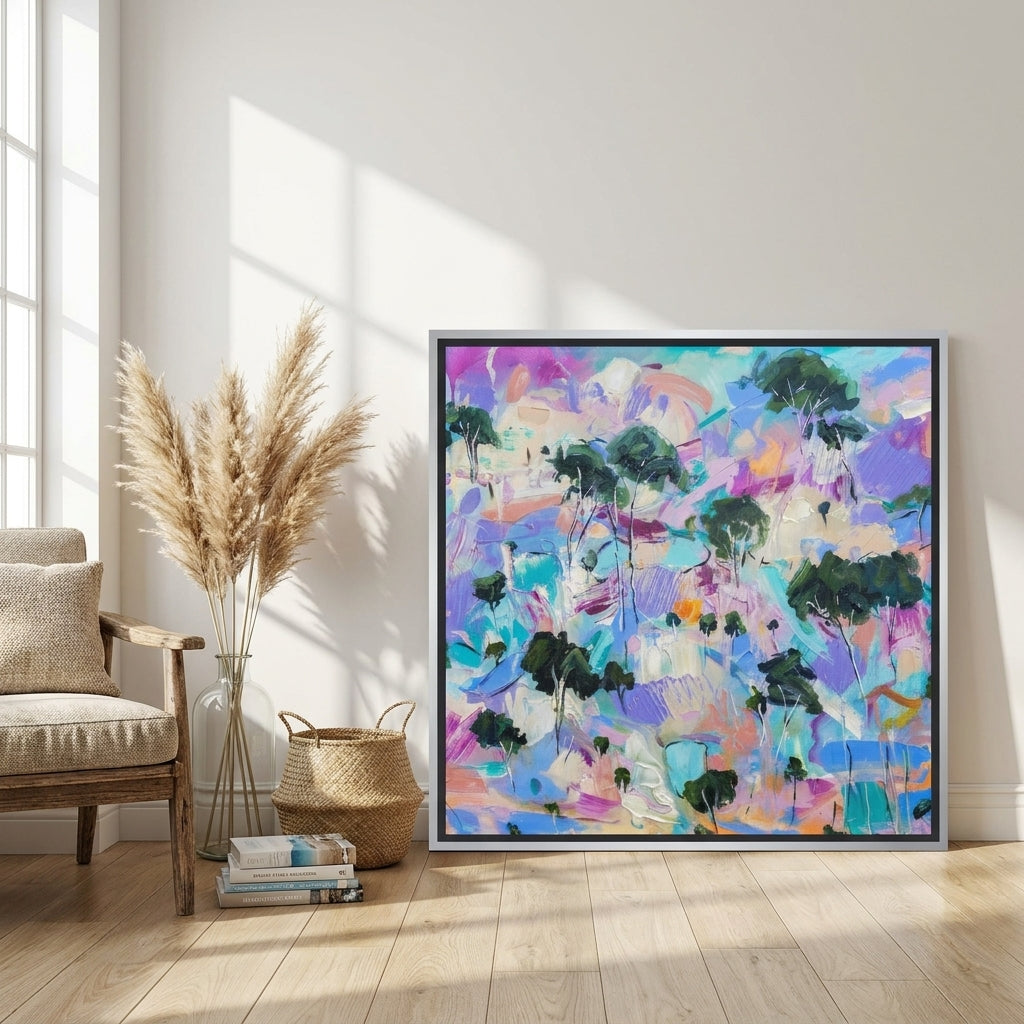 Canvas wall art with a silver leaf surround leaning against the wall in a coastal living room