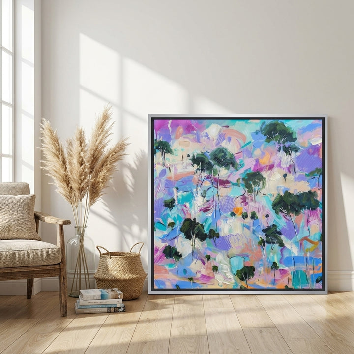 Canvas wall art with a silver leaf surround leaning against the wall in a coastal living room