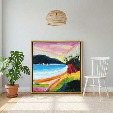 Canvas wall art with a gold leaf surround leaning against the wall in a bright Scandinavian home office