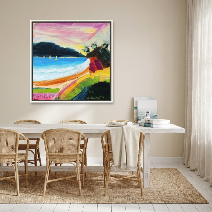 Canvas wall art with a white surround styled on the wall in a coastal dining room
