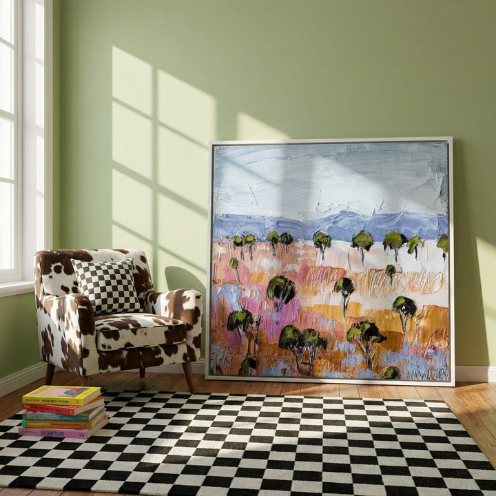 Canvas wall art with a white surround leaning against the wall in a colourful eclectic bedroom