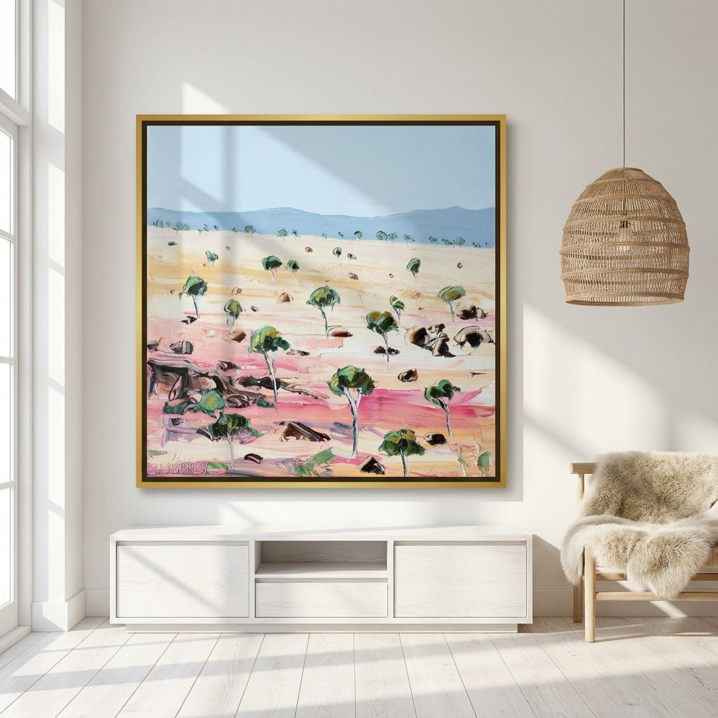 Oversized statement canvas wall art with a gold leaf surround styled on the wall in a bright Scandinavian living room
