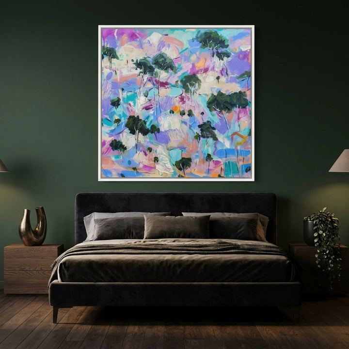 Canvas wall art with a white surround styled on the wall in a moody bedroom