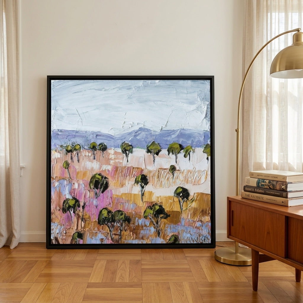 Oversized statement canvas wall art with a black surround leaning against the wall in a mid-century dining room