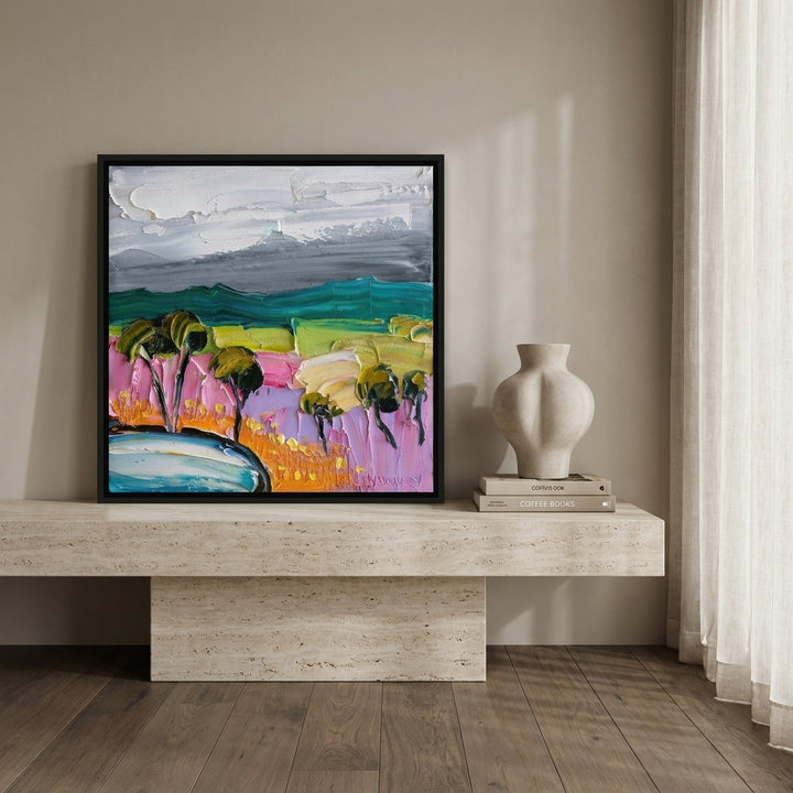 Canvas wall art with a black surround standing on a console in a luxe home office