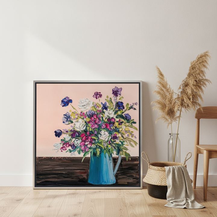 Canvas wall art with a silver leaf surround leaning against the wall in a coastal dining room