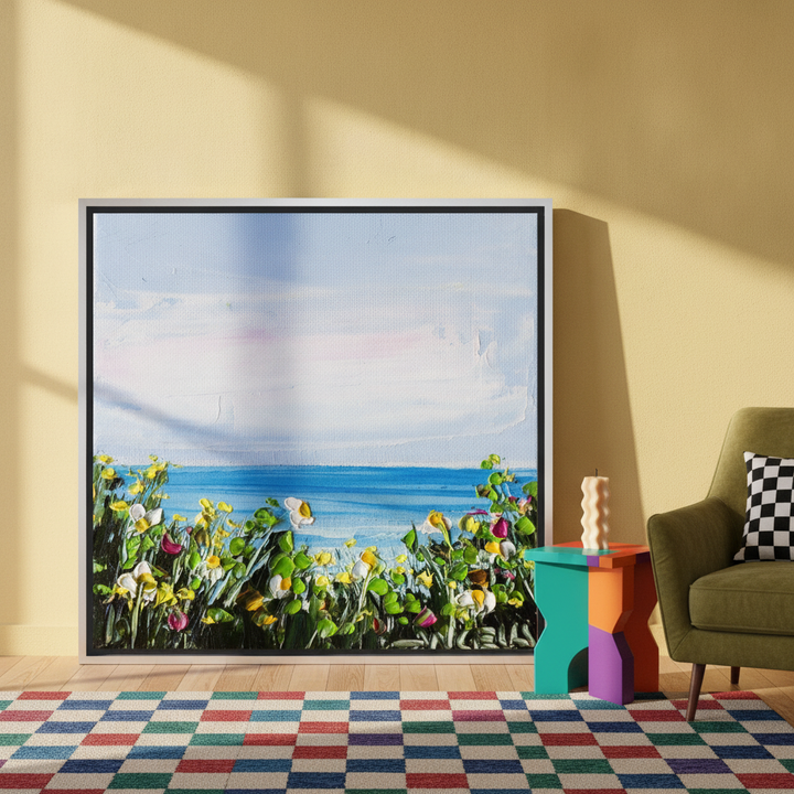 Oversized statement canvas wall art with a silver leaf surround leaning against the wall in a colourful eclectic living room