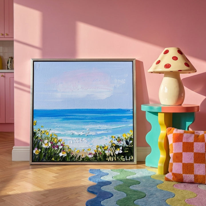 Canvas wall art with a silver leaf surround leaning against the wall in a colourful eclectic kitchen