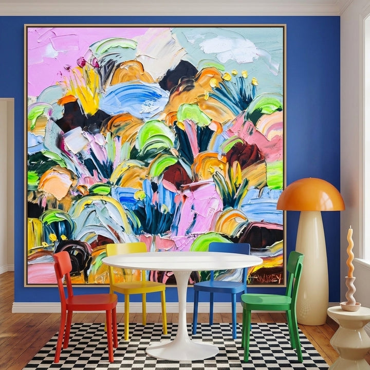 Oversized statement canvas wall art with a natural timber surround styled on the wall in a colourful eclectic dining room