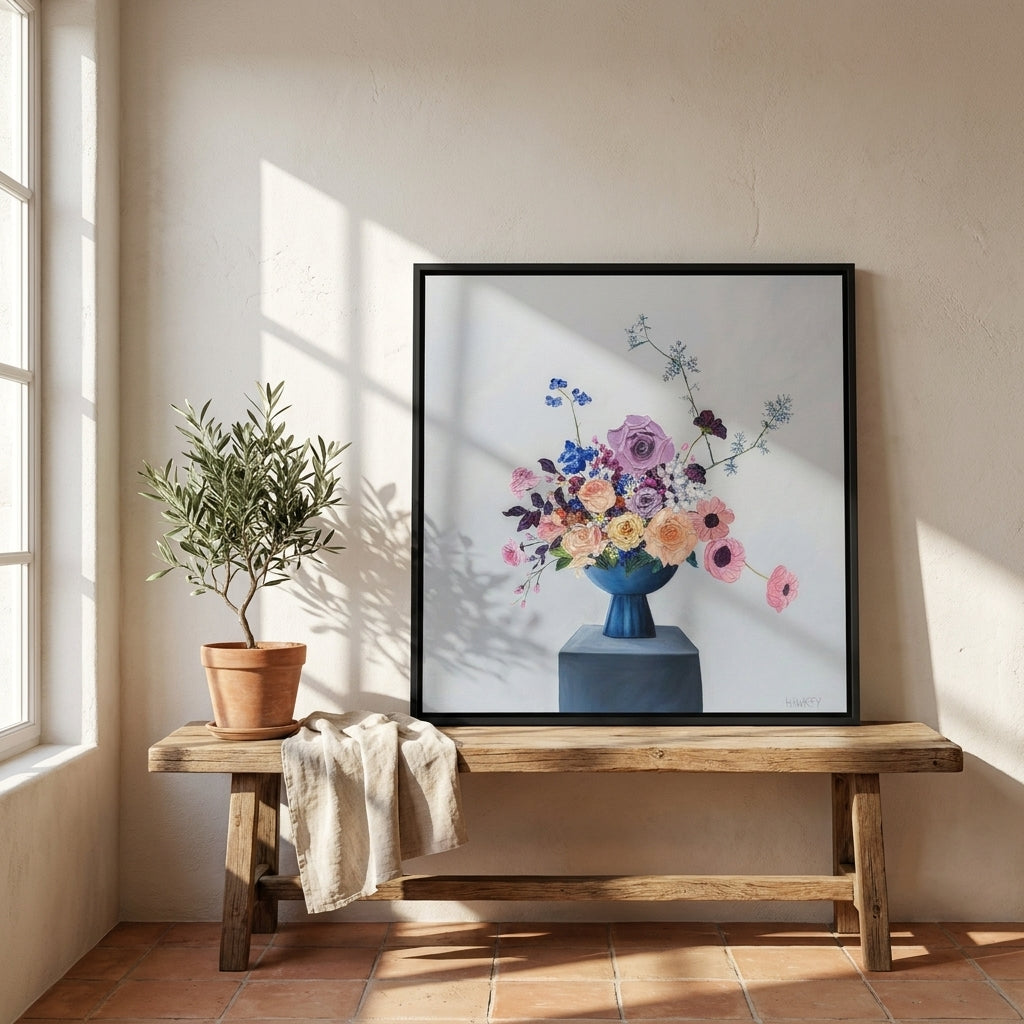 Canvas wall art with a black surround standing on a bench in a Mediterranean bedroom