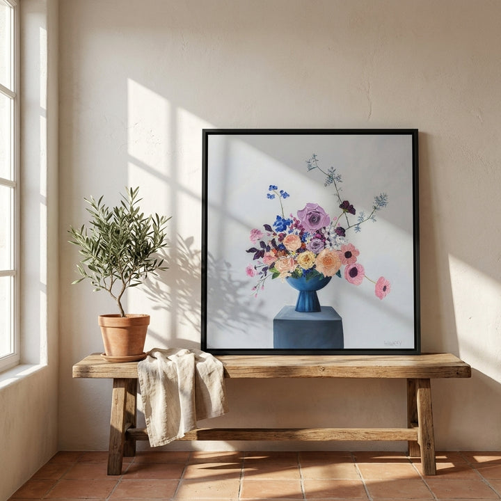 Canvas wall art with a black surround standing on a bench in a Mediterranean bedroom