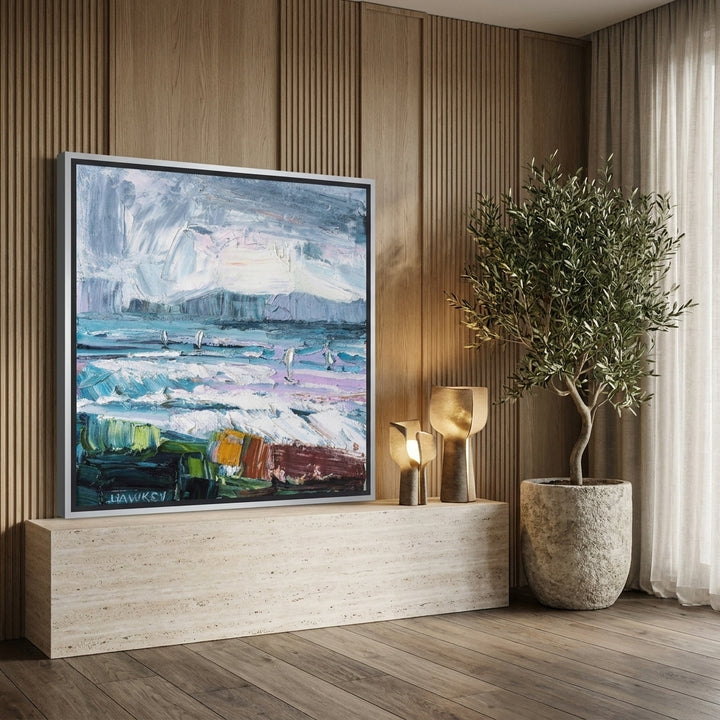 Canvas wall art with a silver leaf surround standing on a console in a luxe bedroom