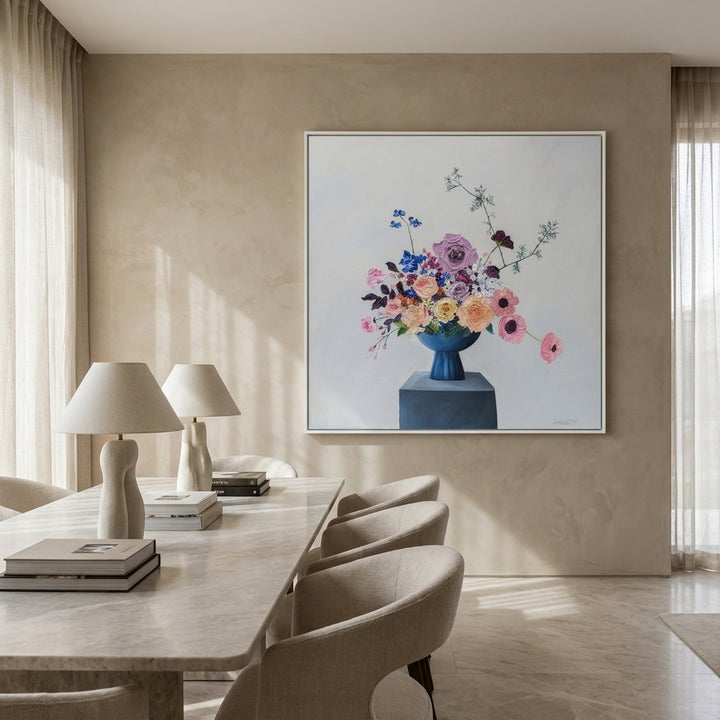 Oversized statement canvas wall art with a white surround styled on the wall in a luxe dining room